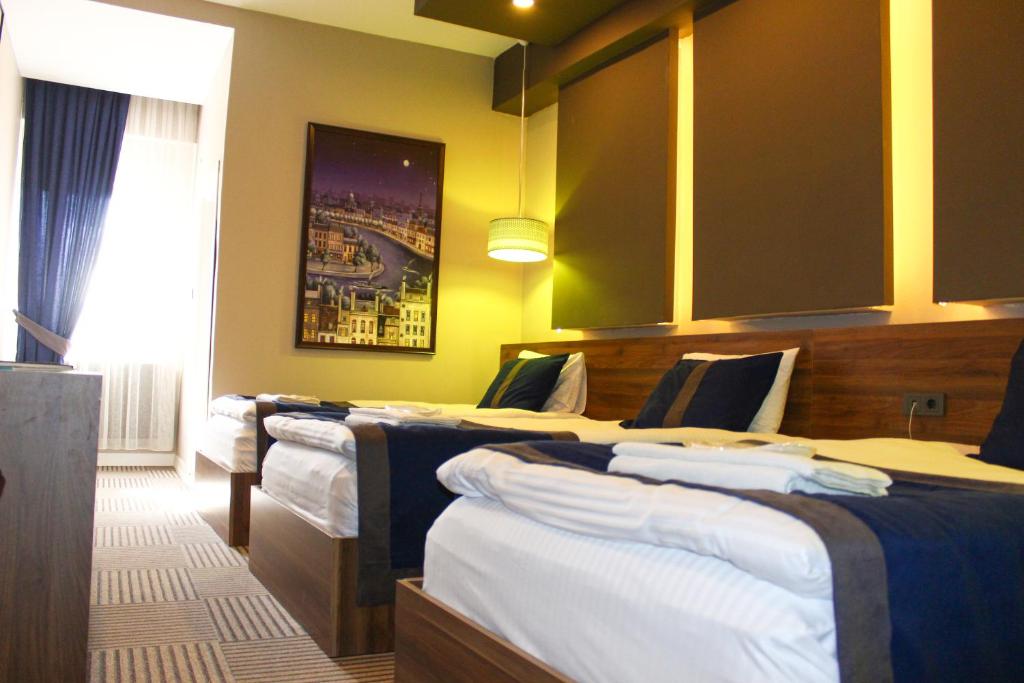 A bed or beds in a room at Grand Catalkaya Hotel