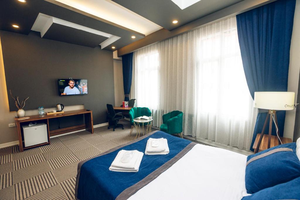 A bed or beds in a room at Grand Catalkaya Hotel