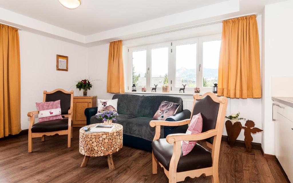 a living room with a couch and two chairs and a table at Baumgartenschneid in Bad Wiessee