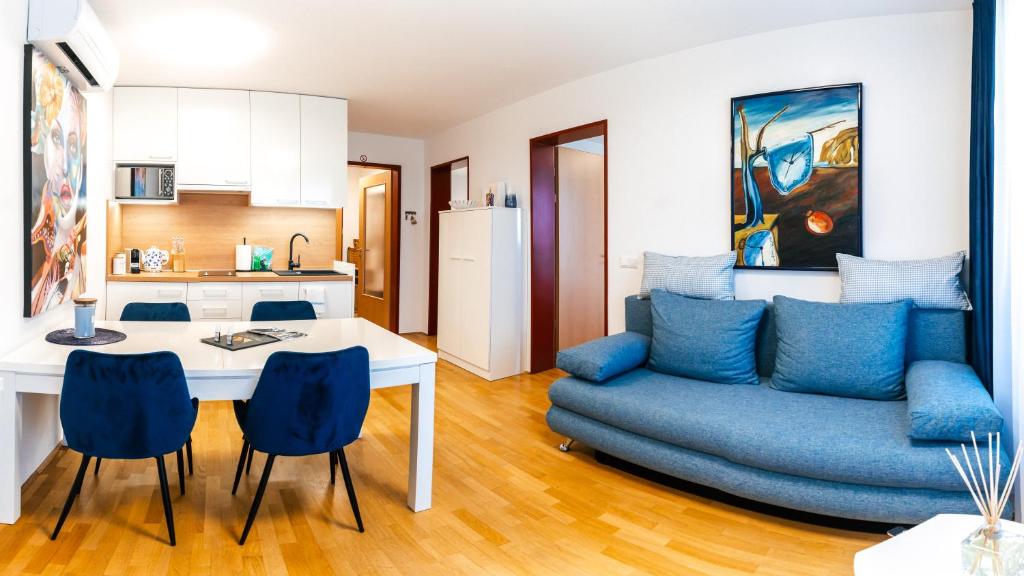 una cucina e un soggiorno con divano e tavolo di Bella Mura Blue Apartment a Moravske Toplice