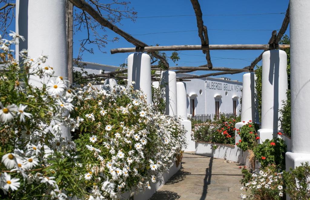 a garden of flowers on a white fence at Hotel Bellavista in Anacapri