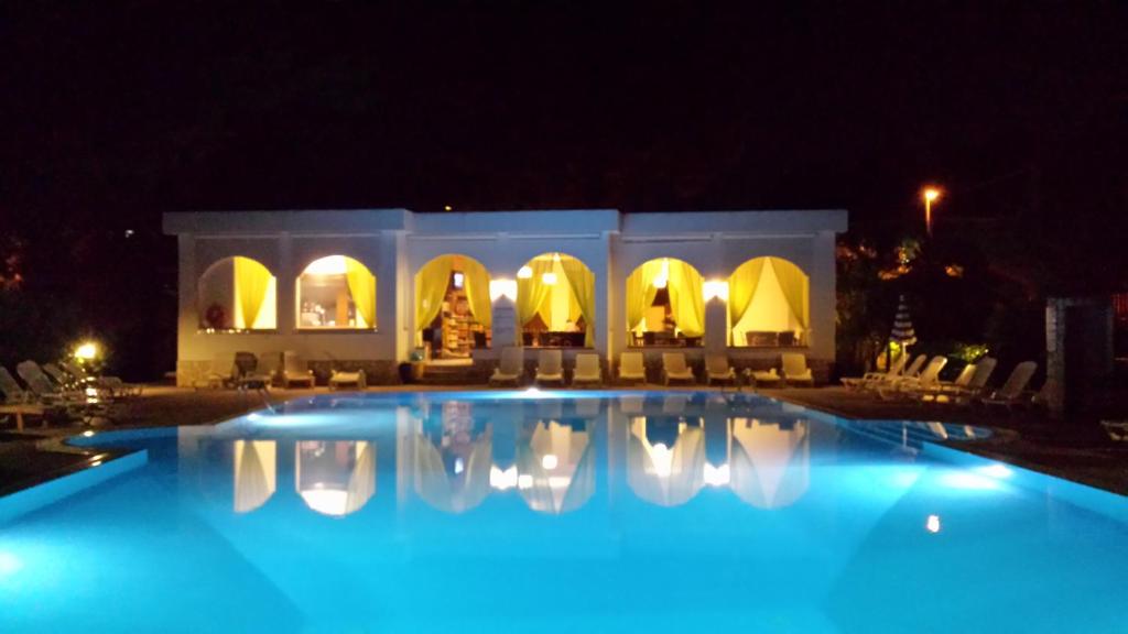 a large swimming pool at night with lights on at Villaggio Alba Chiara in Vieste