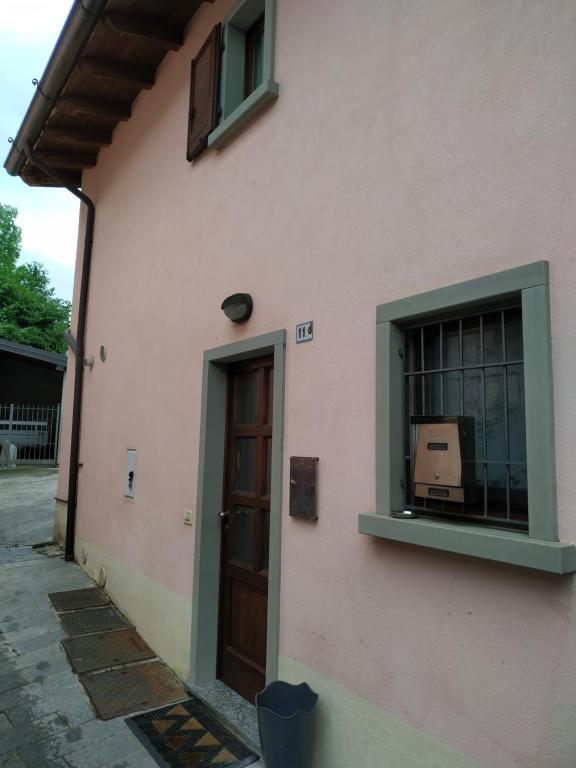 a pink building with a door and a window at DA BRUNA in Rovetta