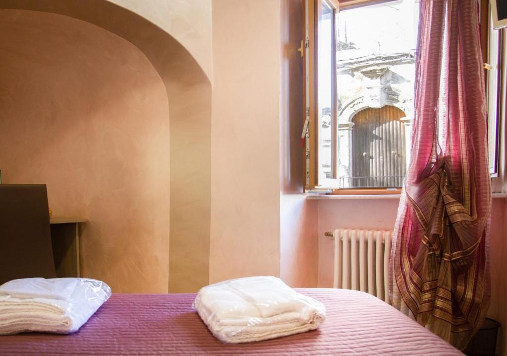 Postel nebo postele na pokoji v ubytování Rooms Gli Arcangeli - Affitti Brevi Italia