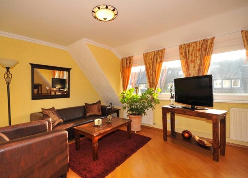 a living room with a couch and a flat screen tv at Deluxe Apartments Bremen Typ D in Bremen