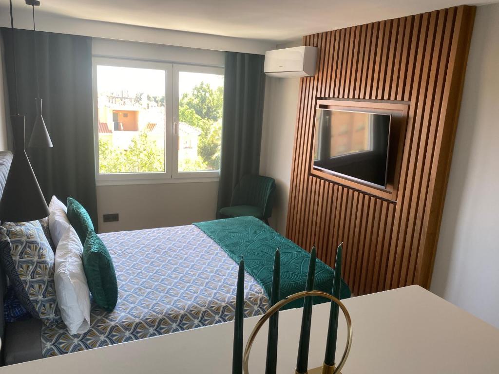 a small bedroom with a bed and a window at Ocean view, Luxury & Relax Dunas de Artola in Marbella