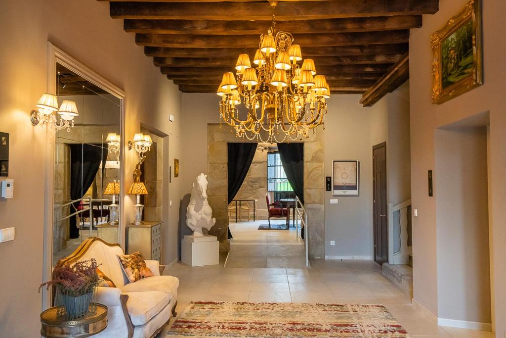 a large living room with a chandelier at Hotel Palacio De Luko in Luco