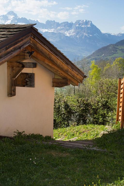 a building with a sign on it with mountains in the background at Chalet cosy proche Tramway du Mont-Blanc et centre in Saint-Gervais-les-Bains