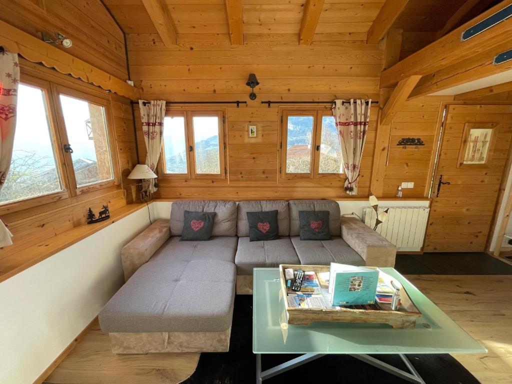 a living room with a couch and a table at Chalet cosy proche Tramway du Mont-Blanc et centre in Saint-Gervais-les-Bains