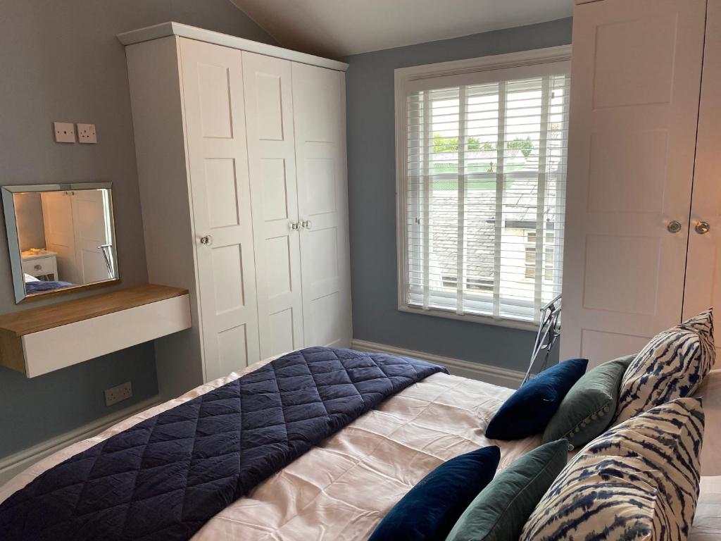 a bedroom with a bed with blue pillows on it at Mayfield Apartment Luxury first floor 1 bedroom apartment in Great Eccleston