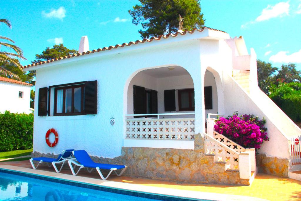 a villa with a swimming pool and a house at Villa Celia in Son Bou