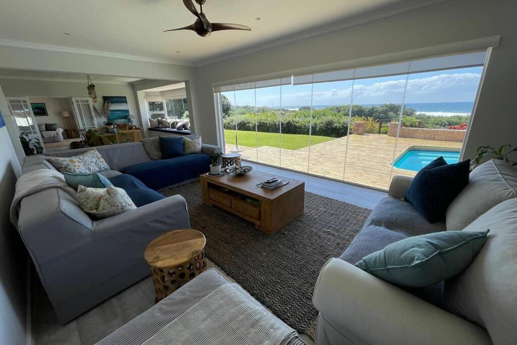 a living room with blue couches and a pool at Gypsea Daze in Pennington