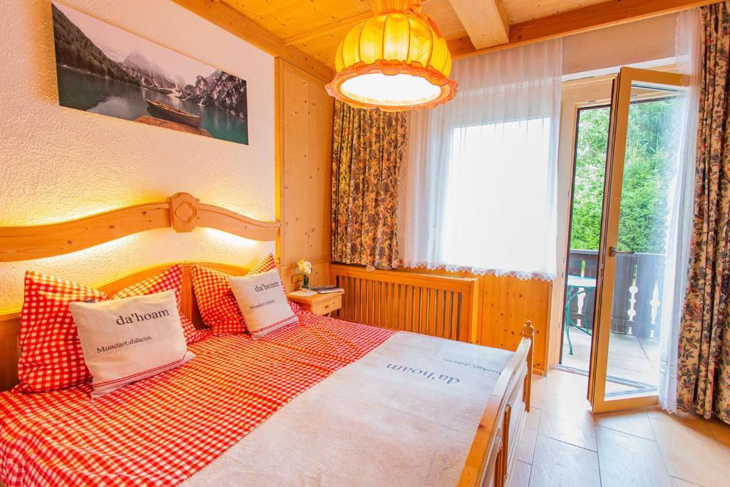 a bedroom with a bed and a large window at Bergidyll 3 by Alpenidyll Apartments in Ramsau am Dachstein