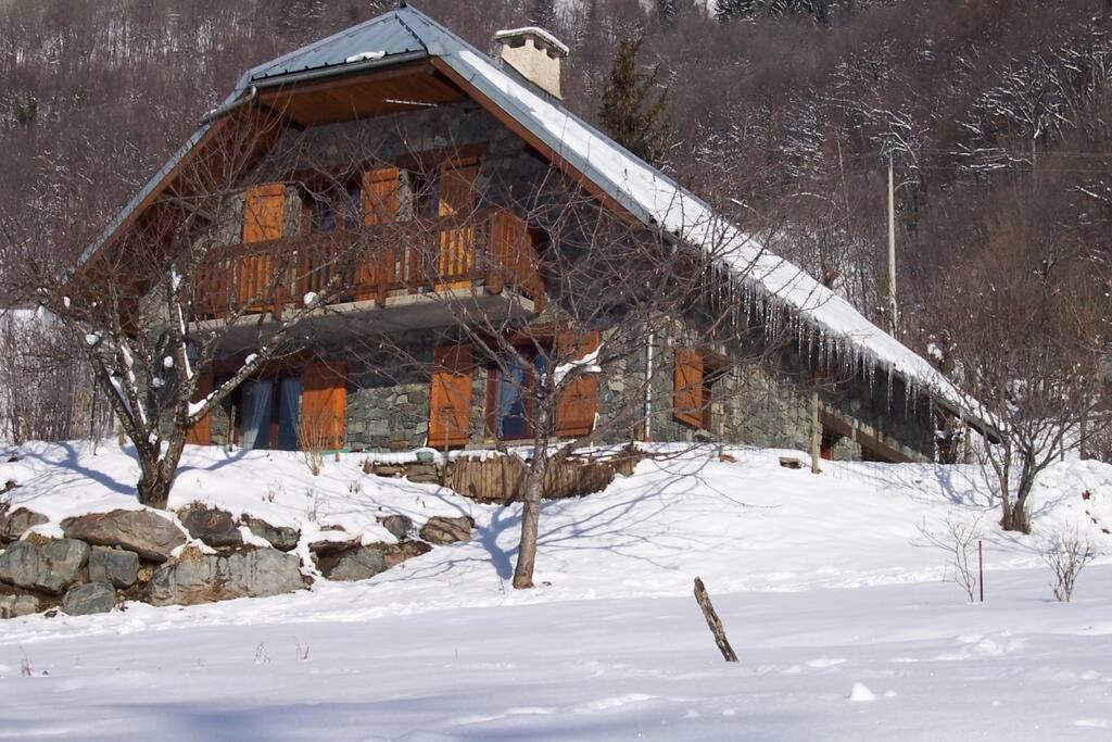 a large log cabin in the snow with snow at Rustic & A Chalet 'Le Sert du Grey - Vaujany in Vaujany