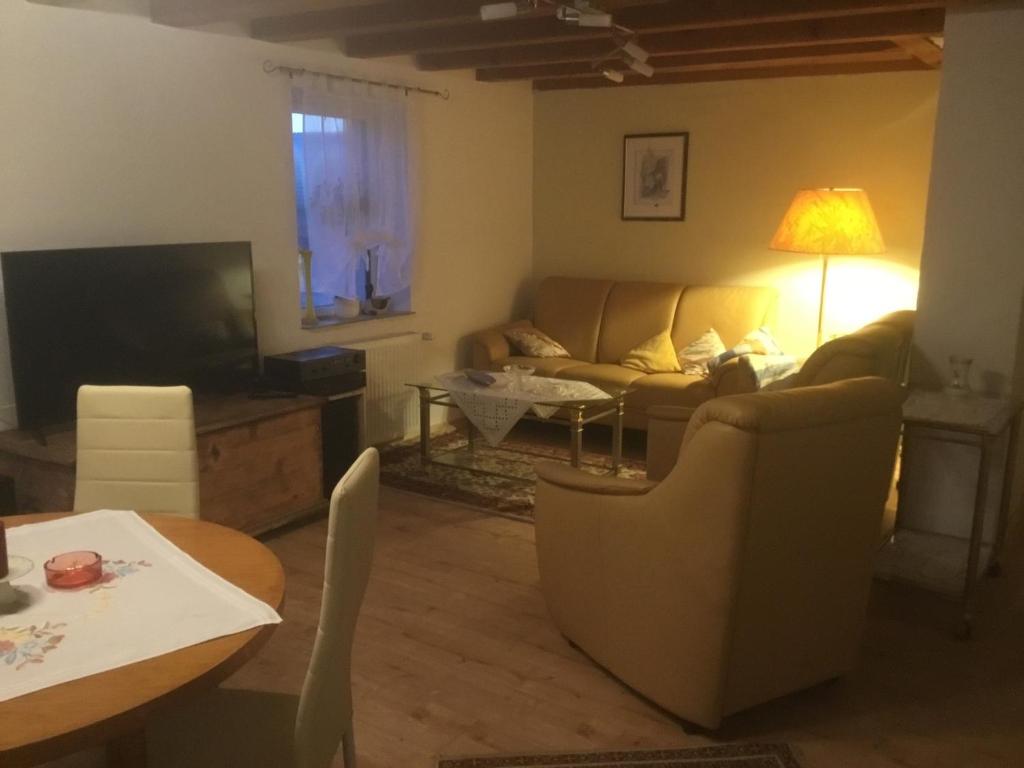 ein Wohnzimmer mit einem Sofa und einem Tisch in der Unterkunft Ferienhaus Störzel Wohnung B in Morbach