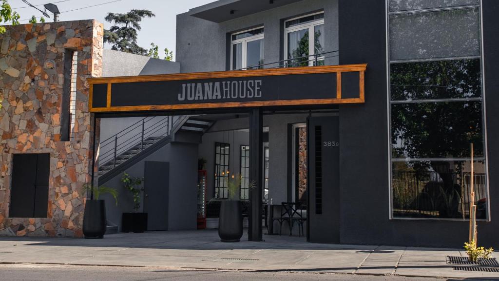 a building with a sign that reads jumanuana house at Juana House in San Juan