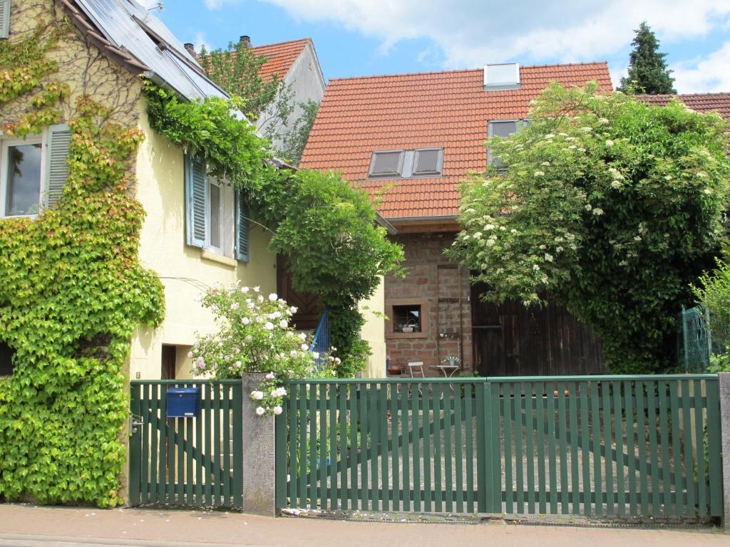 ein grüner Zaun vor einem Haus in der Unterkunft Ferienwohnung Spessart - a13250 in Straßbessenbach