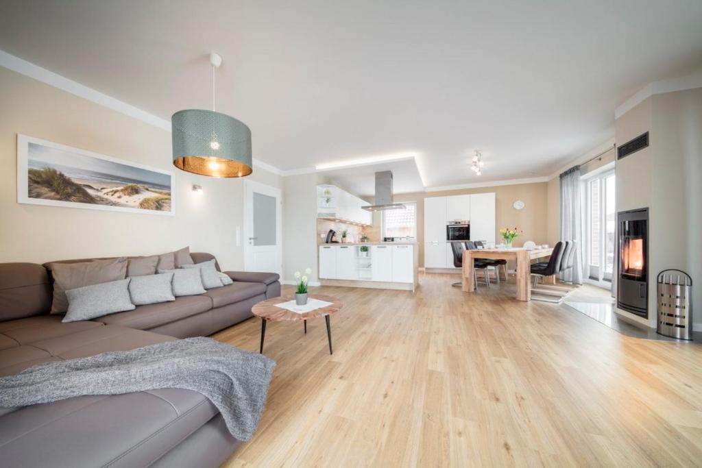 a living room with a couch and a table at Ferienhaus Seeblick - 78913 in Gammendorf