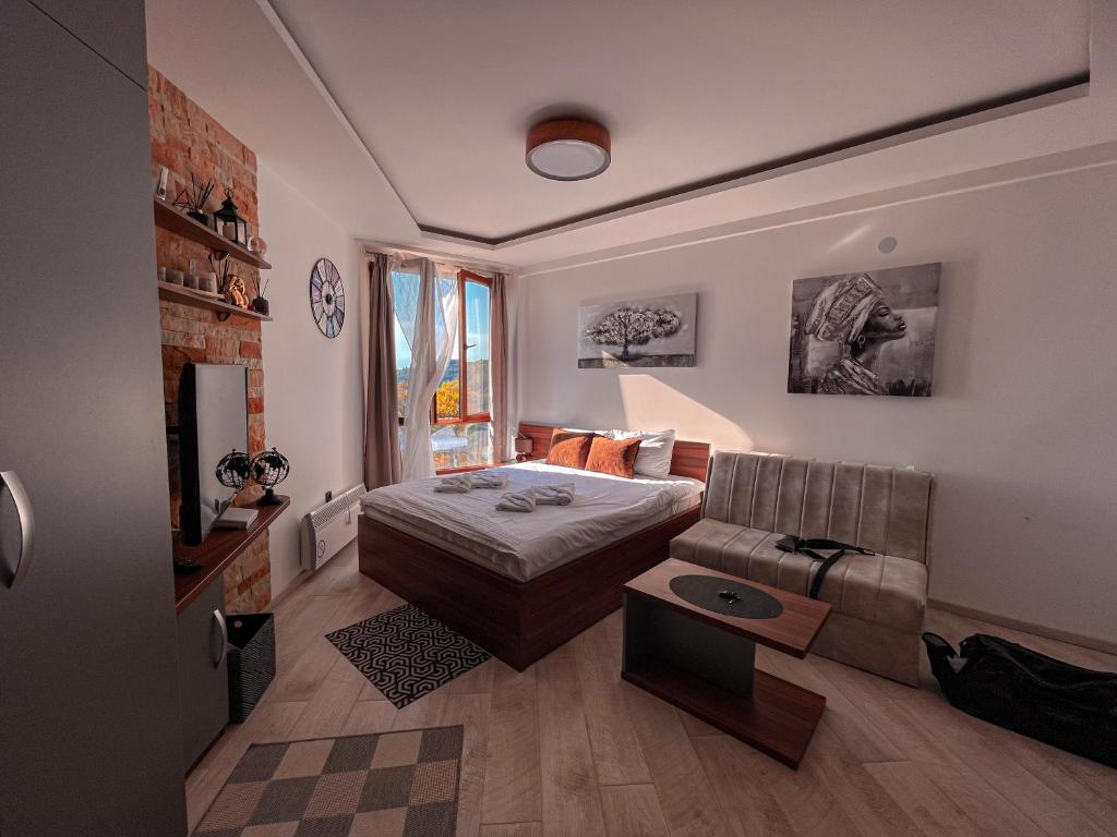 salon z łóżkiem i kanapą w obiekcie Apartman BIG Milmari S19 w mieście Kopaonik