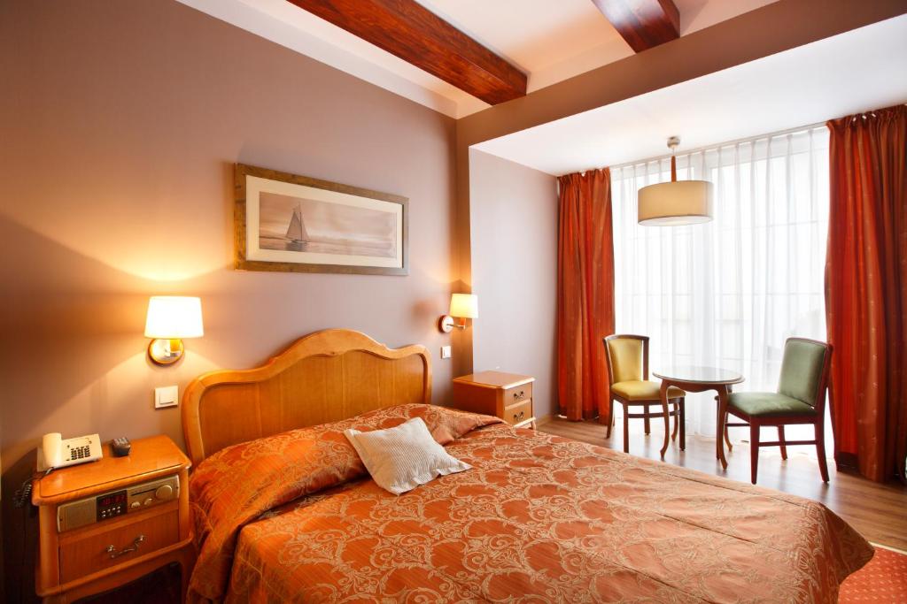 Ein Bett oder Betten in einem Zimmer der Unterkunft Meduza Hotel &amp; Spa