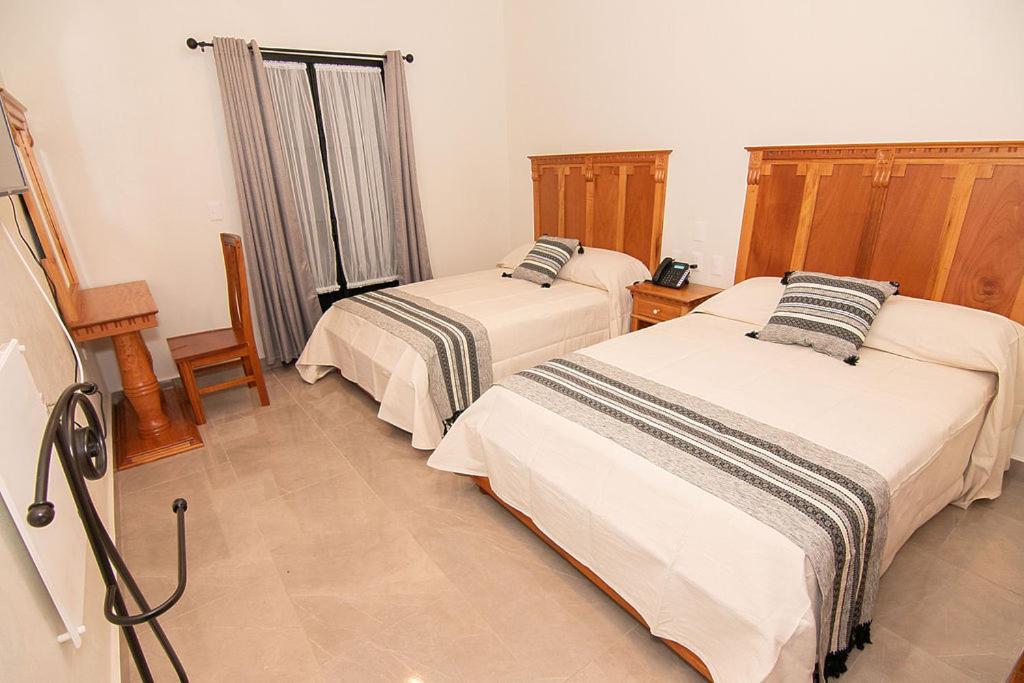 Postel nebo postele na pokoji v ubytování Hotel Danini