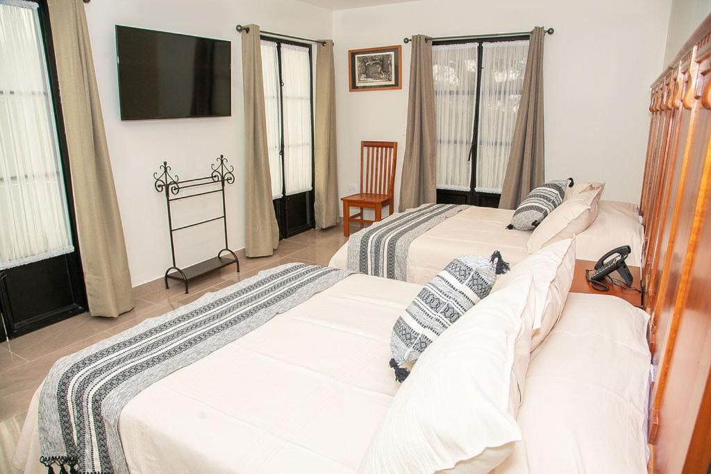 Postel nebo postele na pokoji v ubytování Hotel Danini