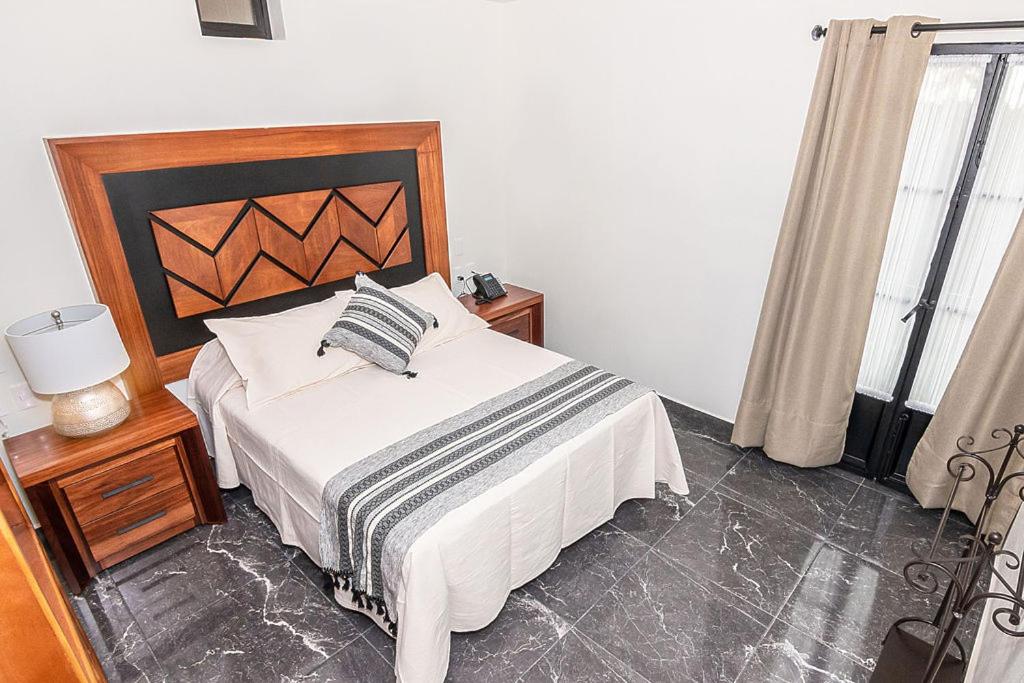 Postel nebo postele na pokoji v ubytování Hotel Danini