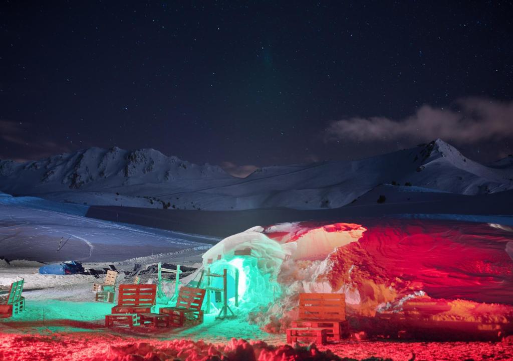 a lit up igloo in the snow at night at Village Igloo Val Thorens in Val Thorens