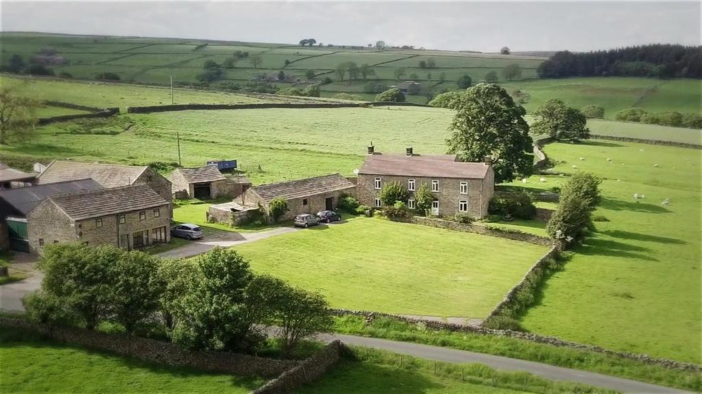 an aerial view of a house in a green field at Pott Hall in Masham