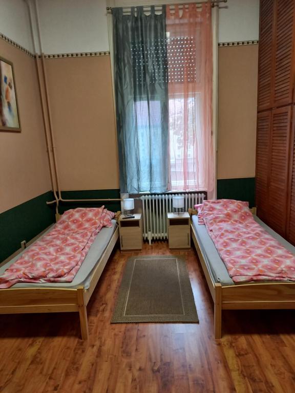 A bed or beds in a room at City Szálló
