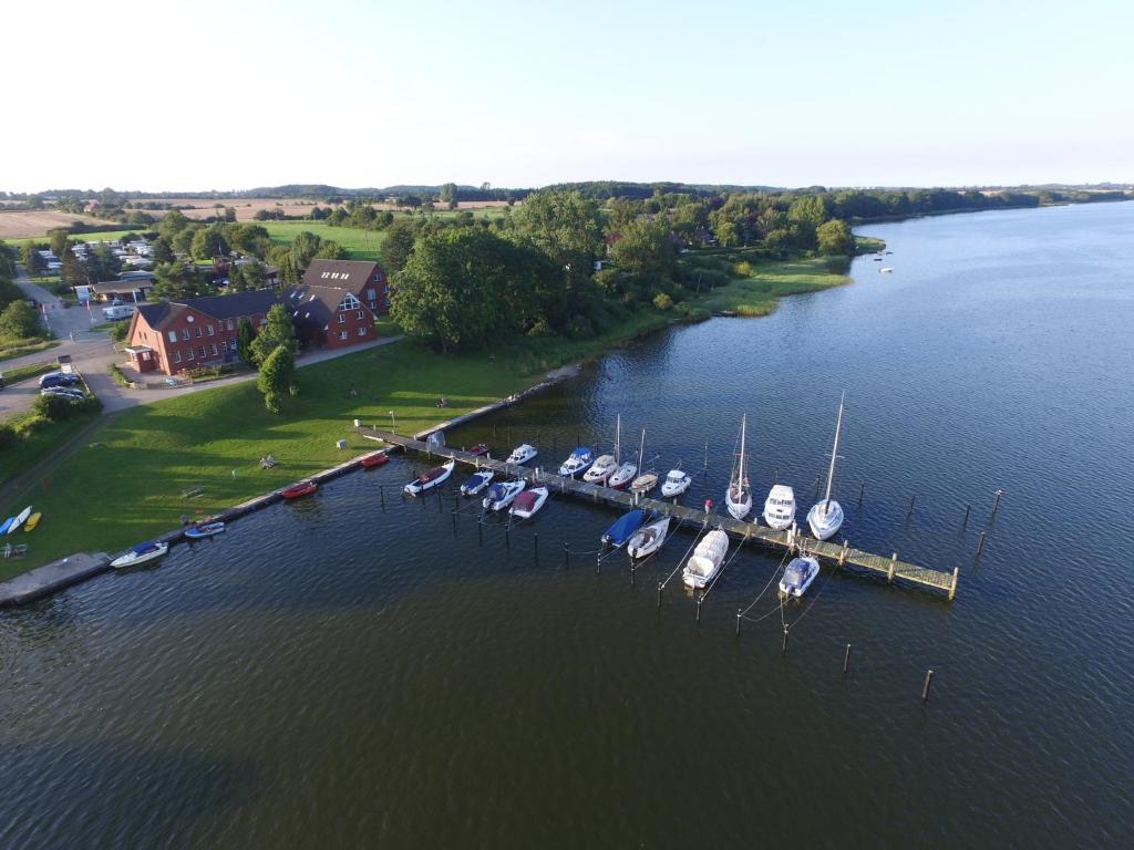 a group of boats docked at a dock in the water at Schleiblick App 5 in Rabenkirchen-Faulück