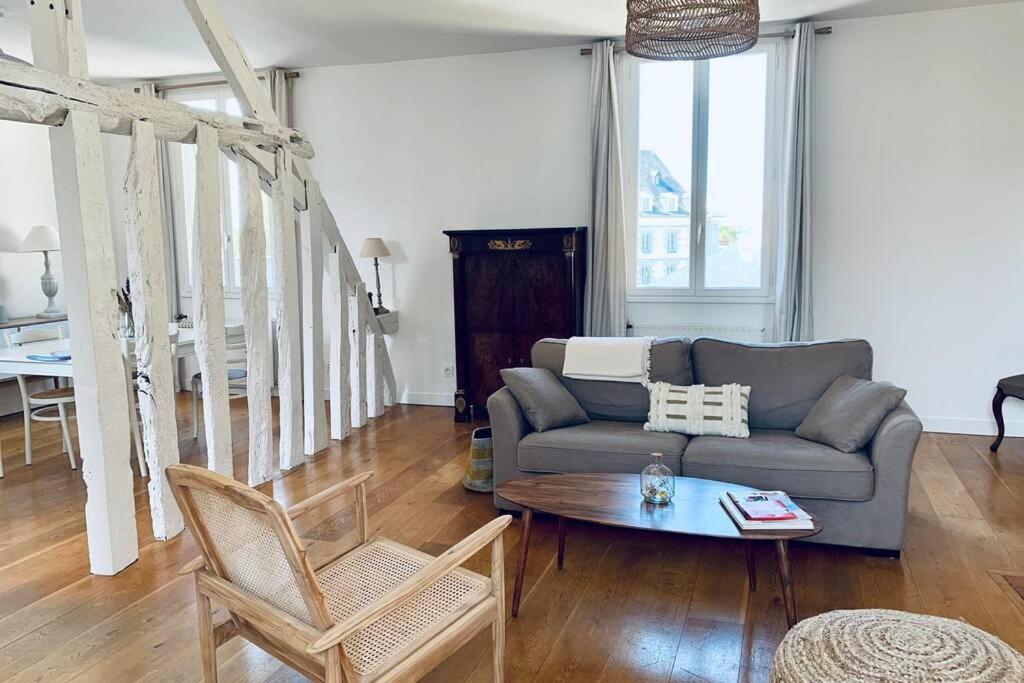 un salon avec un canapé et une table dans l'établissement Le Saint - Louis, proche Jacobin et les Lices, à Rennes