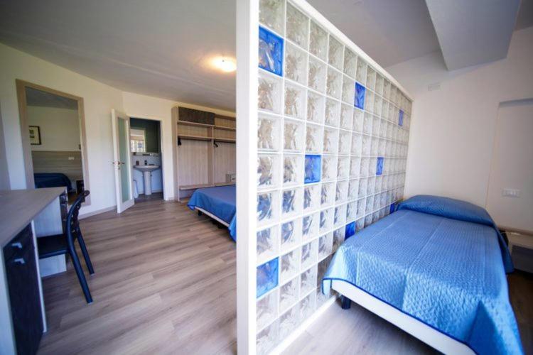 Postel nebo postele na pokoji v ubytování Hotel Capo Di Stella