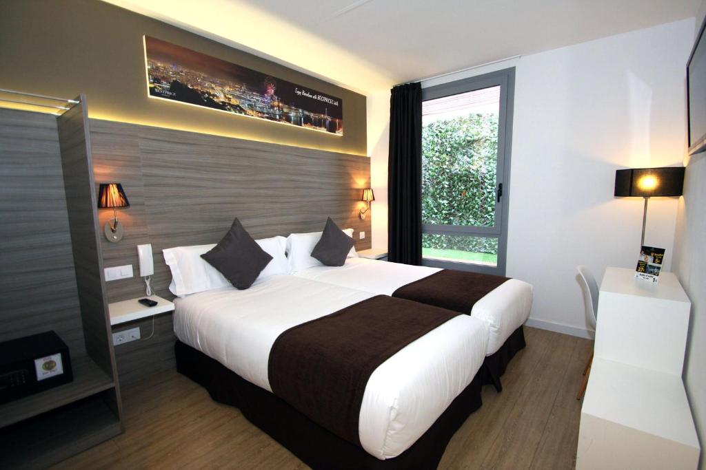 ein Hotelzimmer mit einem großen Bett und einem Fenster in der Unterkunft Hotel BESTPRICE Diagonal in Barcelona