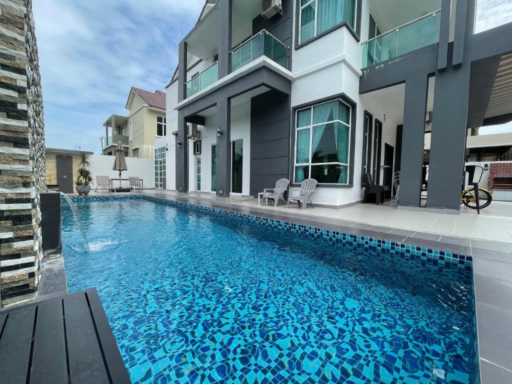 a swimming pool in front of a building at Spacious Home with Private Swimming Pool in Langkawi by Zervin in Kuah
