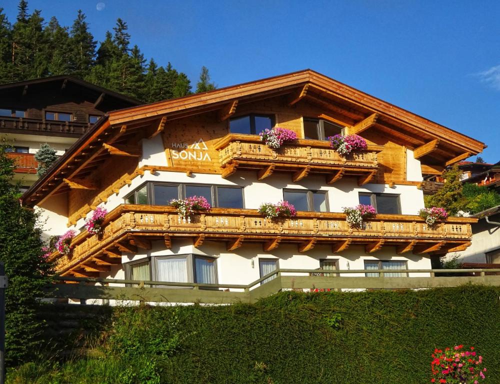 a building with a balcony with flowers on it at Haus Sonja in Seefeld in Tirol
