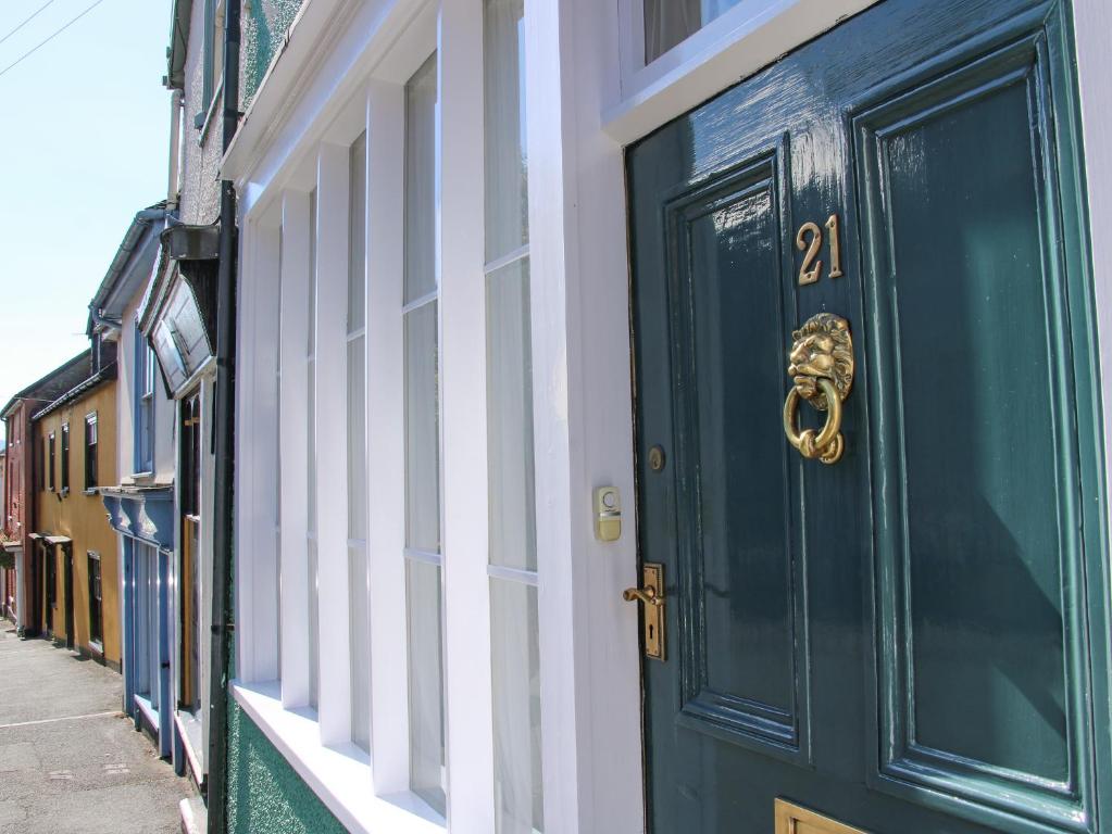 a blue door on the side of a building at 21 High Street in Bishops Castle