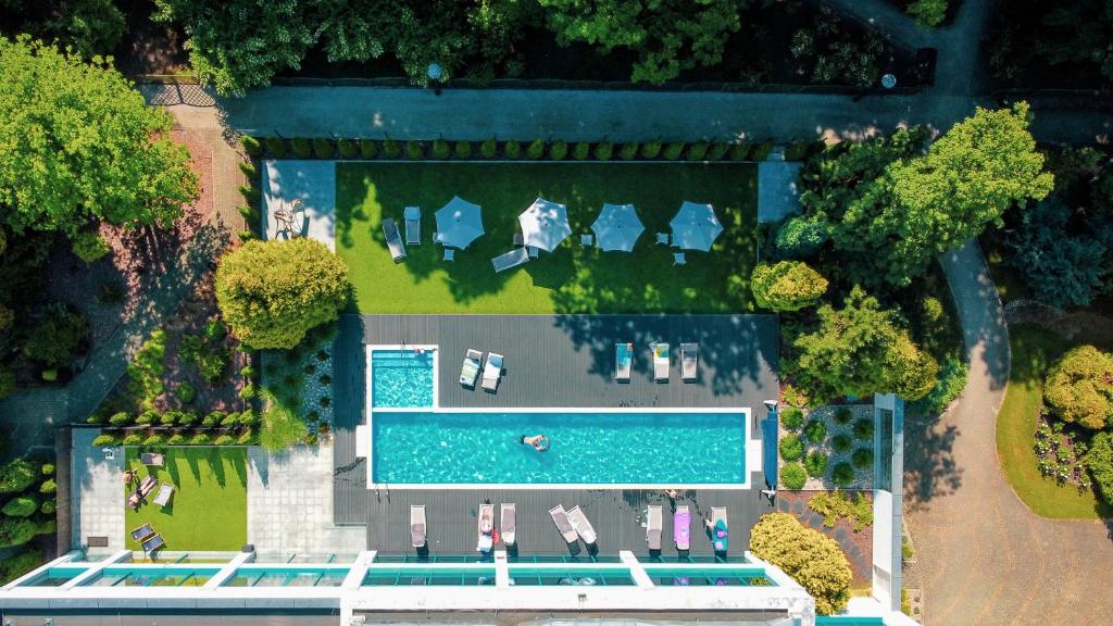 uma vista superior de uma piscina com um grupo de carros em Villa Park Med. & SPA em Ciechocinek