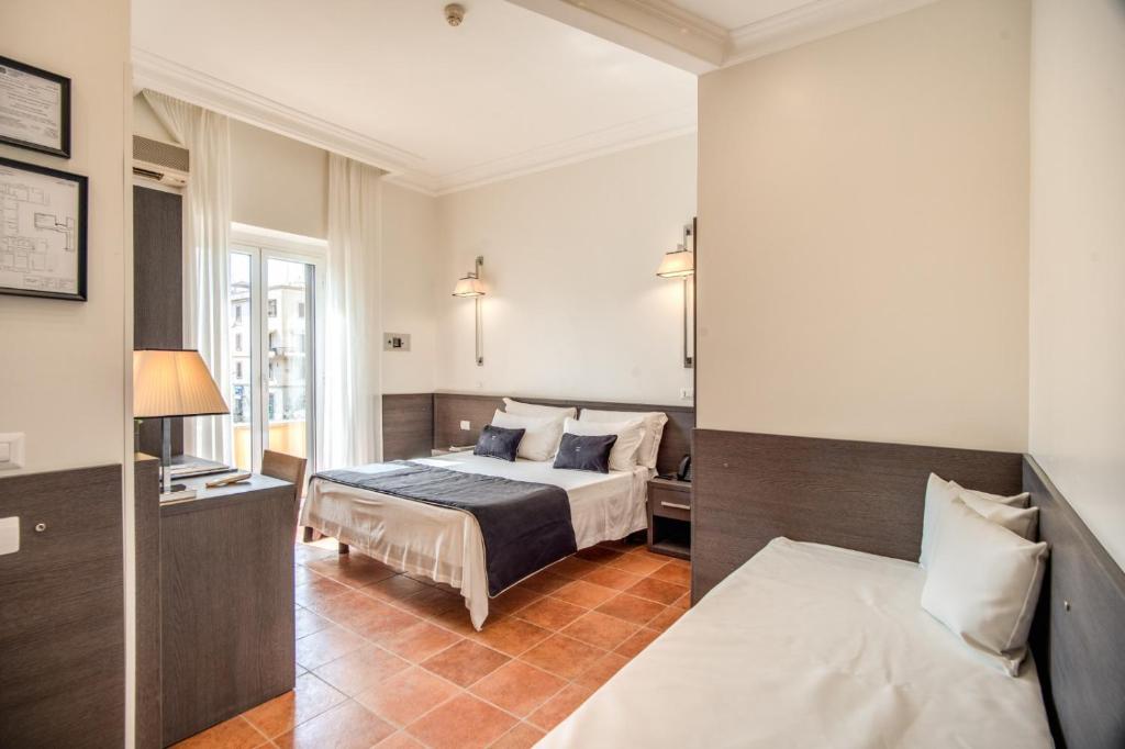 Postel nebo postele na pokoji v ubytování Hotel Mirti