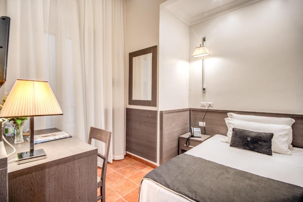 Postel nebo postele na pokoji v ubytování Hotel Mirti