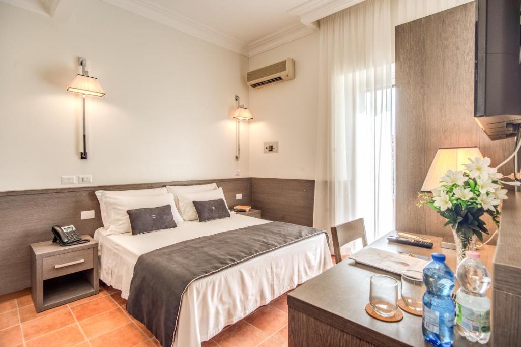 Postel nebo postele na pokoji v ubytování Hotel Mirti