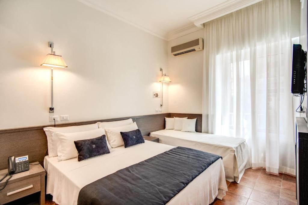 Postel nebo postele na pokoji v ubytování Hotel Mirti