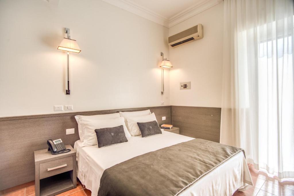 Postel nebo postele na pokoji v ubytování Hotel Mirti