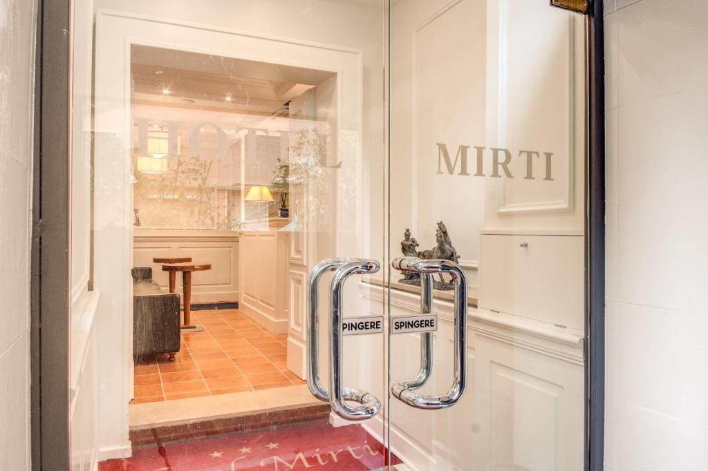 a store window with a mittitt sign on the door at Hotel Mirti in Rome