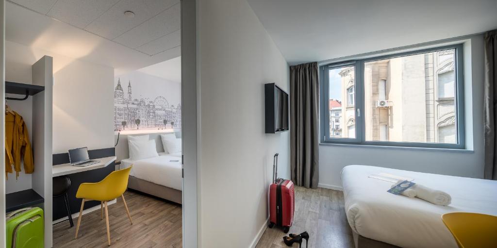 a hotel room with a bed and a window at B&B Hotel Budapest City in Budapest