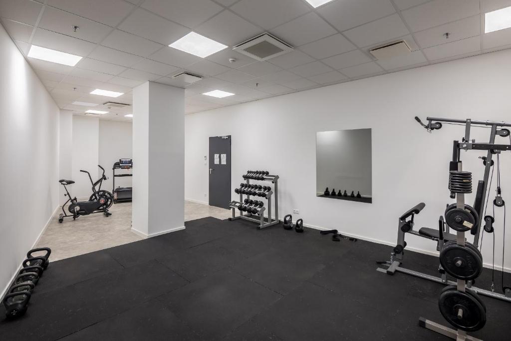a gym with several treadmills and exercise bikes at B&B Hotel Budapest City in Budapest
