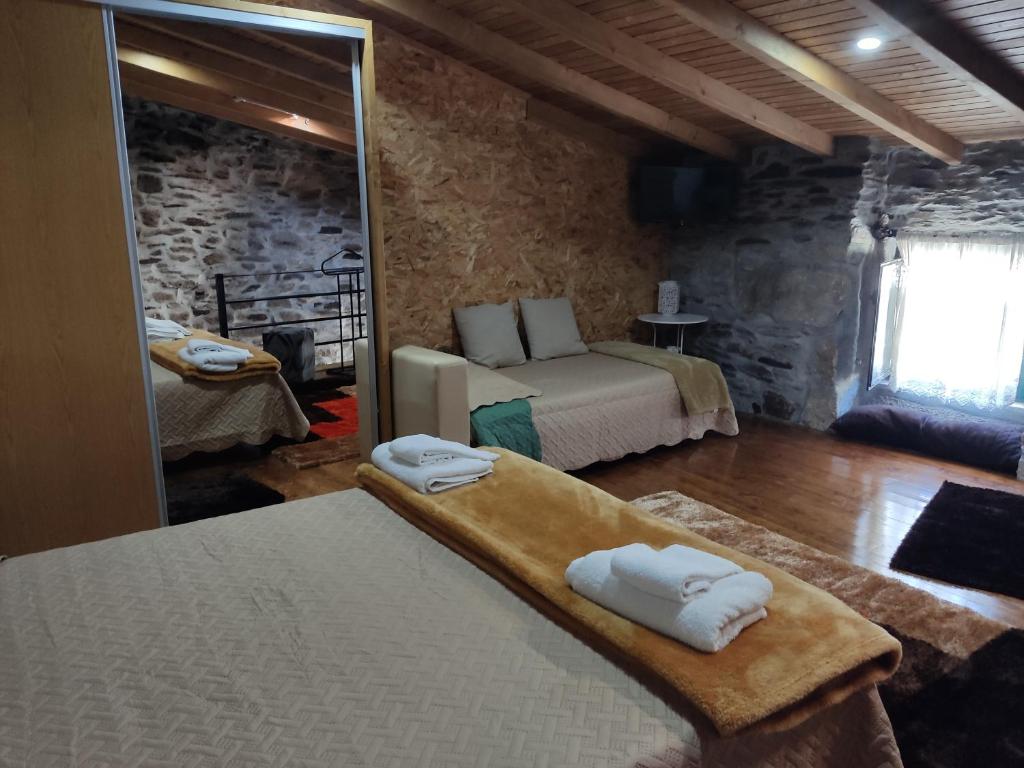 a bedroom with a bed and a mirror in a room at Refugio d'Anita Douro Valley House in Barcos