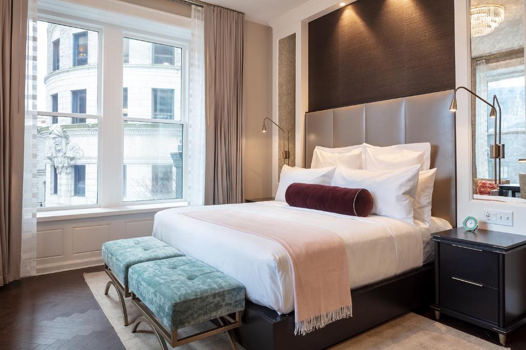 a bedroom with a large bed and a large window at The Beatrice in Providence