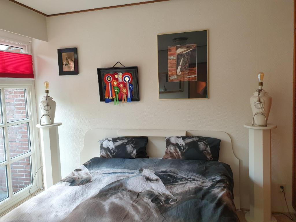 VrieschelooにあるWestert Hoeveのベッドルーム1室(ベッド1台付)が備わります。壁には絵画が飾られています。
