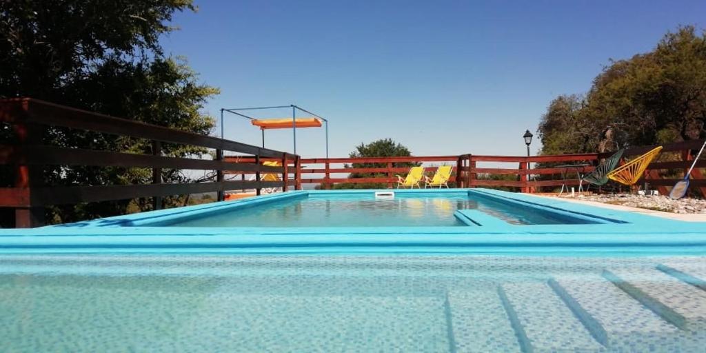 a large swimming pool with a fence around it at Corazon de Montaña in Merlo
